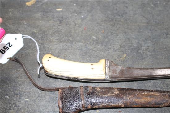 An Indian dagger pesh kabz, ivory grips, silver covered hilt and leather scabbard, late 18th century, overall length 31.5cm